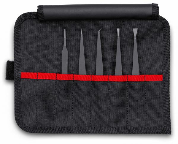 The image shows a black tool bag that is unfolded. Inside there are five black tools of various shapes and lengths, neatly arranged within a red seam.