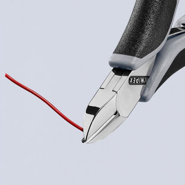 The image shows a pair of pliers with a smooth, shiny blade and a red-painted wire held firmly between the jaws. The handle is black, non-slip.