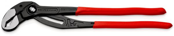 The image shows a black pipe wrench with a red, non-slip grip. The wrench has an adjustable head with serrated edges for gripping pipes and other objects.