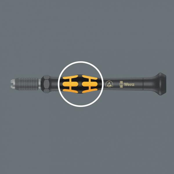 The image shows a black screwdriver with an ergonomic handle. The handle has orange rubber inserts for better grip. Note the Wera brand.