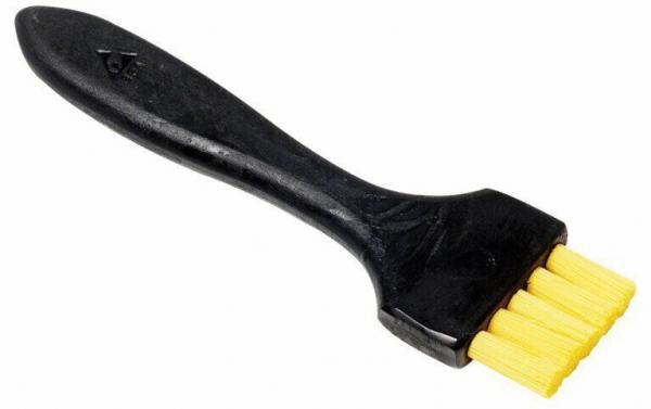 The image shows a plastic brush with a black handle and a working surface with four yellow bristles. It is probably used for cleaning or scrubbing.