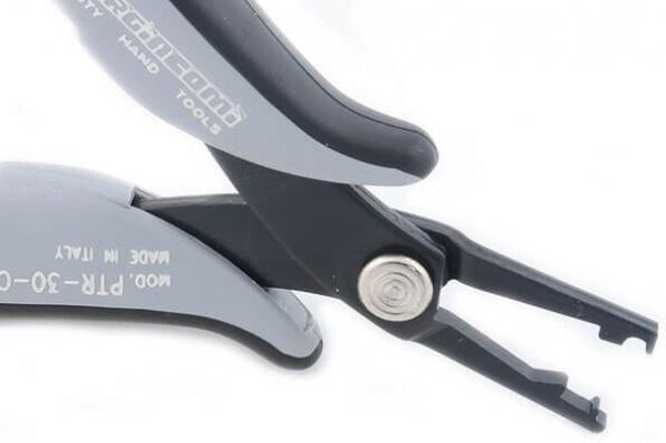 The image shows a pair of pliers with gray handles and a black, pointed working surface. The handle is ergonomically shaped, and the pliers have two claws for gripping or pulling.