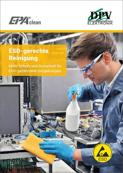 In the picture, there is a worker in protective clothing working at a table with electronics. He is holding a spray bottle and a sponge to safely clean areas at risk of ESD.