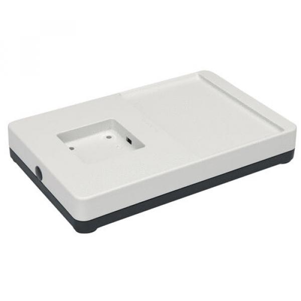 The image displays a rectangular, flat plastic tray. It features a smooth, white surface with a small indentation and an extended area on the right side. The bottom is dark.