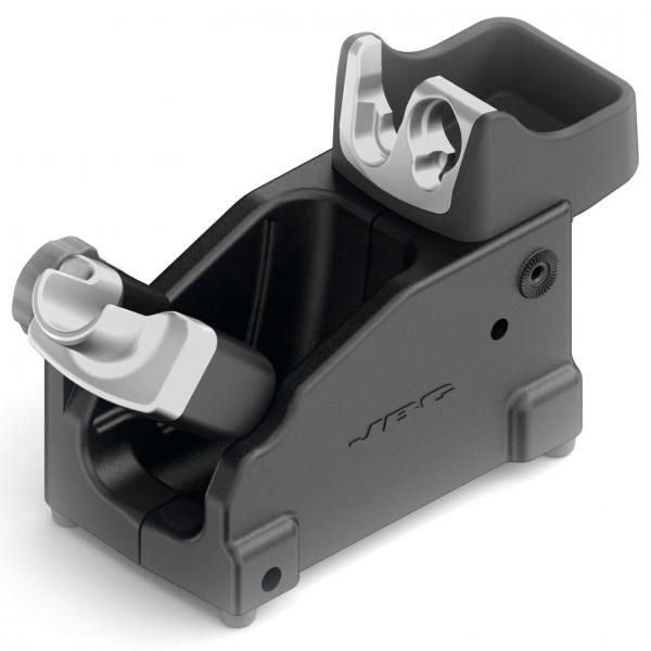 The image shows a black bracket with gray elements. It has a simple, rectangular shape with two slots for inserting devices. On one side, there is an adjustable wheel.