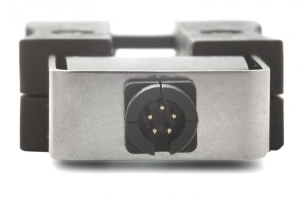The image shows a metallic plug with a round socket that has five metallic contacts. The plug is framed in a gray holder with black edges.