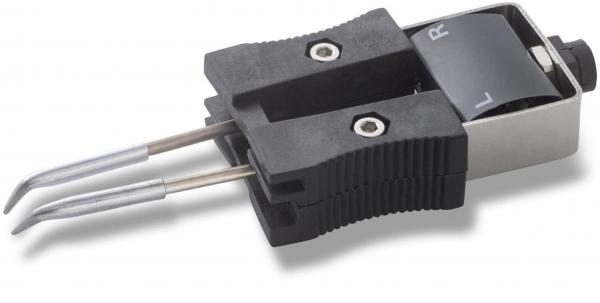 The image shows an electrical switch with two long metal guides. The switch has a rubberized surface and a rotary knob that can be set to the position "L" or "R".