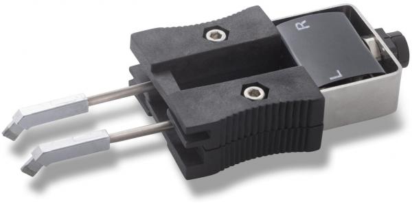 The image shows a technical device with a black handle section and two long, metallic tongs. On the top, there is a switch labeled with the letters "L" and "R".