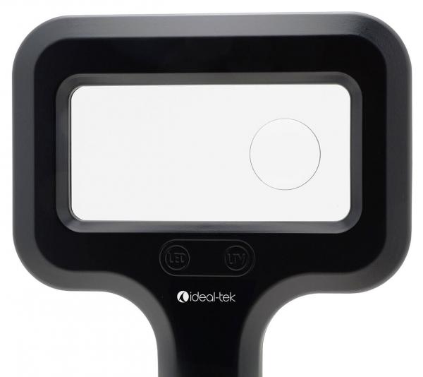 The image shows a black magnifying glass with a rectangular lens and two buttons below it. The top edge is rounded, and the bottom has a wide, ergonomic shape.