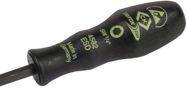 The image shows a screwdriver with a black, non-slip handle and a flat end. Green lettering on the handle provides information about the tool.