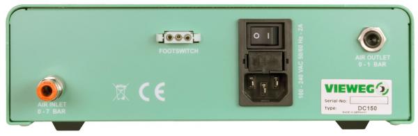 The image shows the back of a green device. It has connectors for air, a foot switch, and a power supply. On the right, there is a switch and an identification sticker.