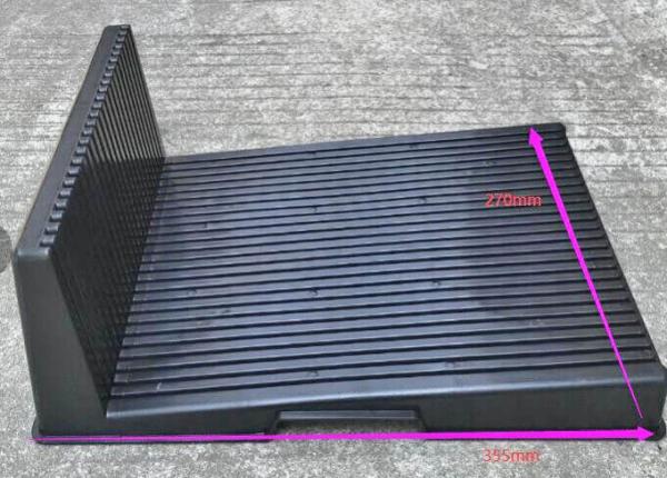 It is a black, flat plastic plate with a raised back. The surface texture is non-slip with parallel grooves. The dimensions are 270 mm high and 385 mm wide.
