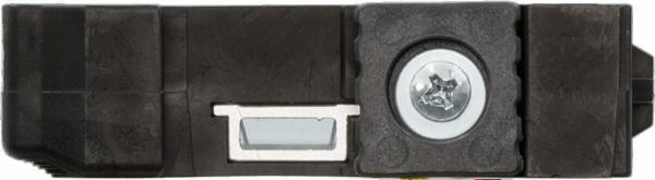 The image shows a black, rectangular plastic component. On one side, there is a round metal piece with a screw. Next to it is a small, rectangular cutout.
