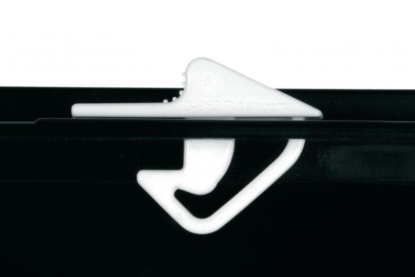 The image shows a white plastic cap positioned on a black part. The cap has a curved shape with a hook and a flat, pointed side.