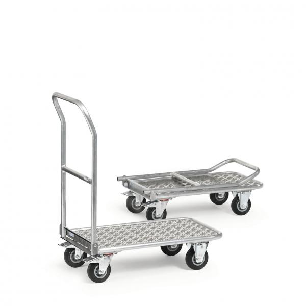 The image shows two metal transport carts. The front one has a long handle and a sturdy surface with metal mesh, which is less pronounced at the back. Both carts have rolling wheels.