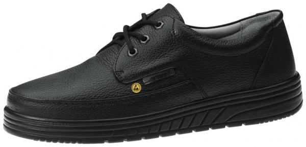 The shoe is black, made of textured leather with a sporty silhouette. It has a flat sole, lacing, and a yellow side marking.