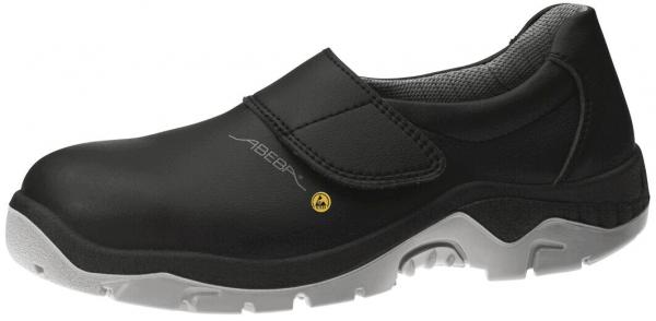 The shoe is black and has a smooth, slightly shiny leather surface. It features a wide Velcro strap and a light, non-slip sole. The shape is comfortable and functional.
