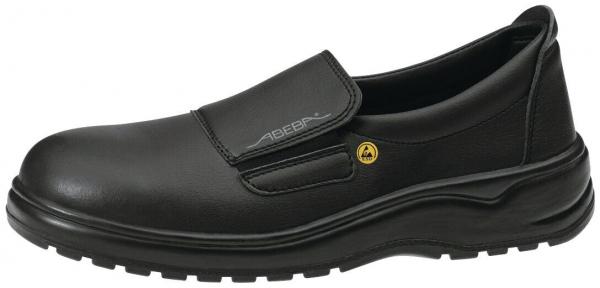 The image shows a black, comfortable men's shoe without laces. It has a flat sole, a wide toe cap, and a Velcro fastener on the instep. The surface is made of smooth leather.