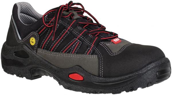 The image shows a sturdy work shoe. It is primarily black with gray and red design elements. The laces are red, and the shoe has a non-slip sole.