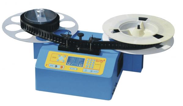 The image shows a blue device with two large, round coils. It has a control interface with buttons and a display. One coil is dark, the other is light.