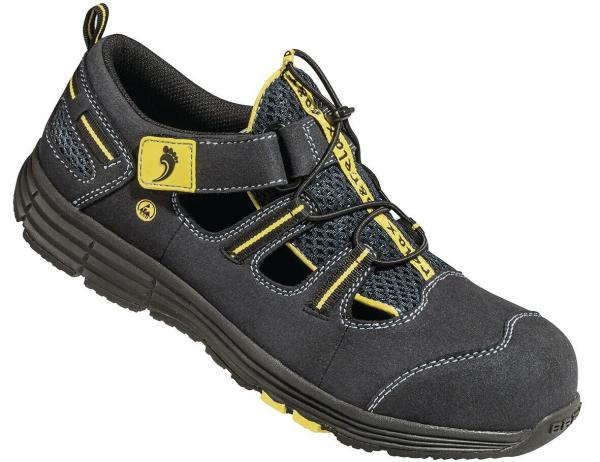 The image shows a black sports shoe with yellow and gray tones. It features a breathable design, quick lacing, and an adjustable strap over the instep. The sole is stable and slip-resistant.