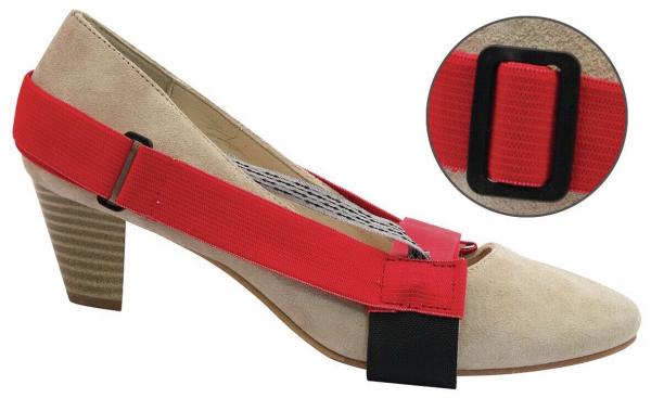 Das Bild zeigt einen beigen High Heel mit einem roten Gummiband, das über den Vorderfuß gespannt ist. Unter dem Schuh ist eine schwarze Halterung sichtbar. Ein kleinerer Ausschnitt zeigt das Gummiband näher.