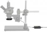 Preview: The image shows a microscope with a stable metal base. It has two eyepieces and a stage for the object. Next to the microscope is a control panel with buttons.