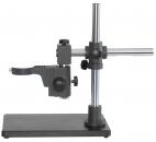Preview: The image shows a microscopic stand with a stable, rectangular base. A vertical, metallic rod supports a swiveling arm with a lens on the left side.