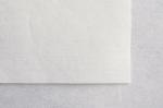 Preview: Das Bild zeigt ein Stück helles, fast weißes Papier auf einer grauen Unterlage. Die Oberfläche des Papiers hat feine, subtile Linien.