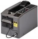 Preview: The image shows a gray device with a smooth surface and a slot on the top. On the front, there are buttons and a compartment for dispensing labels or tickets.