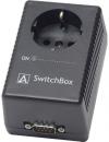 Preview: It is a black, rectangular device with an outlet on top and a serial interface on the bottom. On the side, there is a switch labeled 