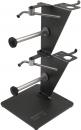 Preview: The image shows a sturdy, rectangular stand made of black metal. It features two vertical tubes that taper upwards, along with various mounts on the top.