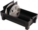 Preview: The image shows a black container with four round, white plates. One of the plates is tilted and two black dividers stand in the box. The structure is functional and simple.