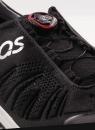 Preview: The image shows a black sports shoe with a tight, breathable material and lacing adjusted by a red-black push button. A logo is visible.