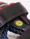 Preview: The image displays a detailed section of a shoe. It is black with red and blue accents. A wide strap made of textured material holds the shoe together, and a yellow logo is visible.