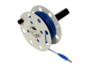 Preview: The image shows a cable reel with blue cord. The reel is round, has a central axis, and several holes in the rim. At one end of the cord, there is a connector plug.