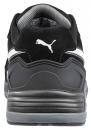 Preview: The image displays the rear view of a black shoe. It features a gray sole and a white stripe. A prominent Puma logo is visible. The shoe appears sporty and modern.