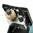 Preview: The image shows the interior of a device. A round brush with stiff bristles is mounted, next to it a metallic block with switches and a cord. The colors are primarily gray and black.