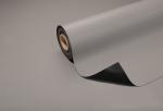 Preview: A gray carpet or mat partially lies on a surface. The roll is rolled up and displays a smooth, matte surface. The underside is dark.