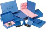 Preview: The image shows several blue boxes, some of which are open. Inside the boxes are pink foam inserts for protecting sensitive items, possibly electronics.