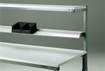 Preview: The image shows a shelf with several horizontal shelves. On the top shelf, there are two black storage boxes. The shelf has a metal structure.