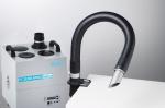 Preview: The image displays a device for extracting vapors. It features a rectangular, silver-colored body with four openings on top and a flexible, hose-like outlet pointing to the right.