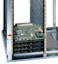 Preview: The image displays a vertical computer rack with multiple green-painted circuit boards. The boards are stacked in a metal casing, equipped with several connectors and slots.