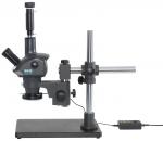 Preview: The image shows a microscope with a stable, black base. It has a telescope-like lens, a lateral eyepiece, and a vertical mount that supports the work area. A cable terminates in a control unit.