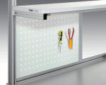 Preview: The image displays a tool wall with a perforated surface. Two tools are hanging on it: a screwdriver with a blue handle and a pair of pliers in red. The wall has a modern, minimalist design.