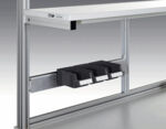 Preview: The image displays a metal structure with a horizontal rail profile. Below it, three black compartments are attached, which are likely used for storage or holding items.