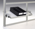 Preview: The image shows a warehouse-like shelving system with a pull-out shelf. On it are two black plastic containers with space for compartments, attached to a sturdy, silver frame.