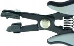 Preview: The image shows a black, ergonomically shaped pliers with gray handles. The pliers have a spring-loaded opening and two pointed gripping arms at the front, which can be moved together.