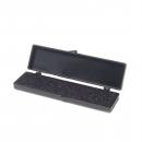 Preview: The image shows a black, rectangular box. It has a lid that can be opened. Inside, there is a textured surface that appears slightly rubberized.