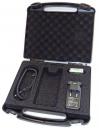 Preview: The image shows an open, black suitcase with foam inserts. Inside the suitcase, there is a charger, a spiral cable, and a free space for another device.